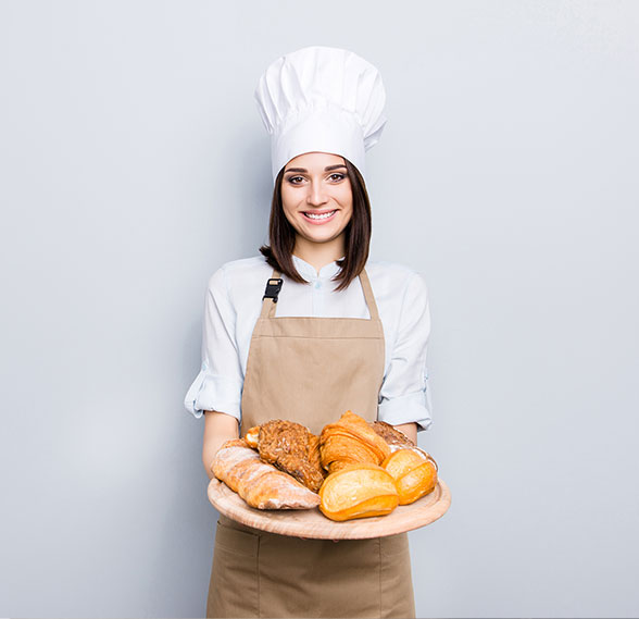 Woman holding a plate of fancy bread