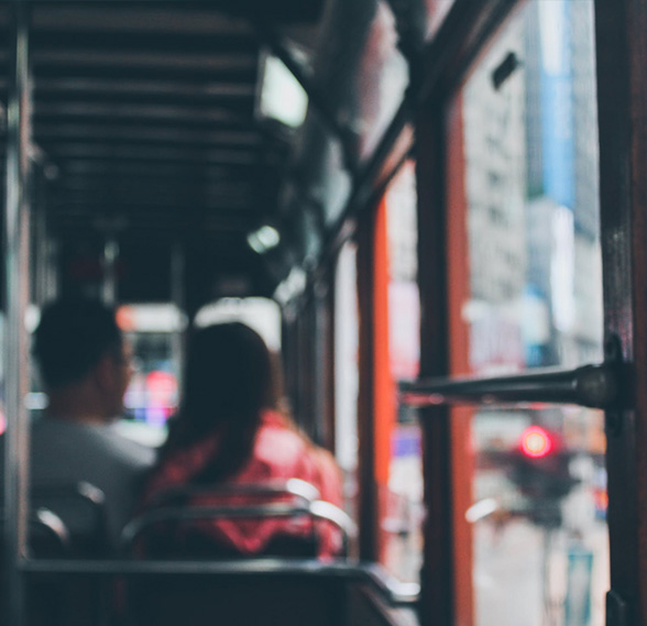 A man and woman riding a bus
